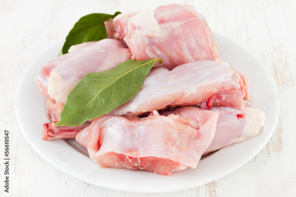 raw rabbit on white plate