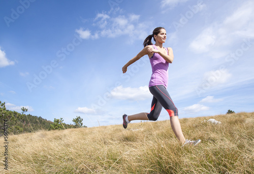 Young woman running outdoors in the nature