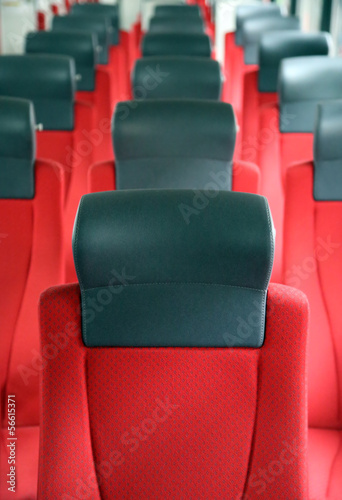 rows of red seats in train