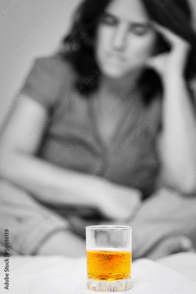Alcohol addict looking at a glass of whiskey Alcohol addict looking at a glass of whiskey