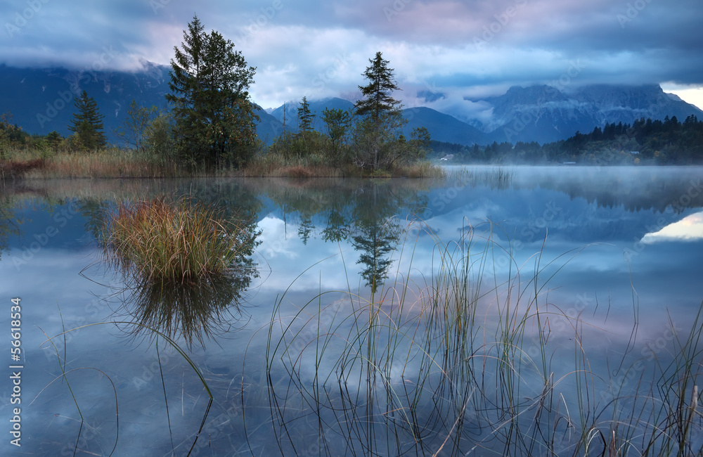 foggy cold sunrise on alpine lake Barmsee