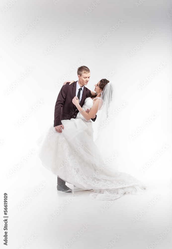 Young newly married couple hugging in studio Young newly married couple hugging in studio