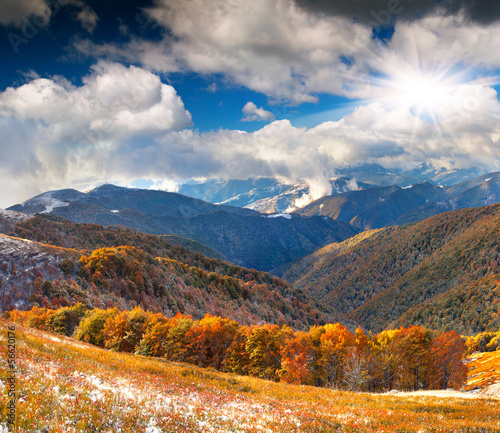 Colorful autumn landscape in the mountains. First November snow