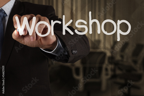 businessman hand writing wrokshop and meeting on crumpled recycl photo