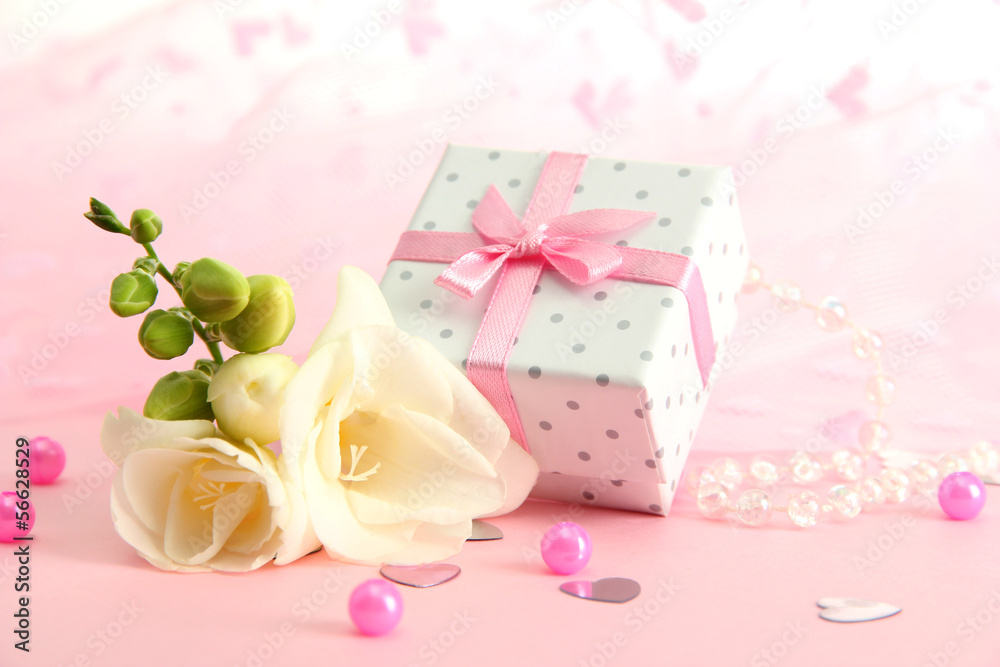 Beautiful romantic gift box and flower on pink background