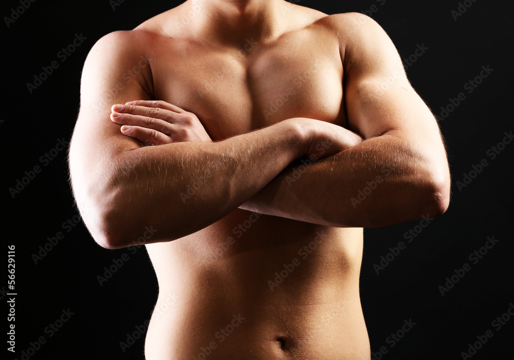 Handsome young muscular sportsman, on dark background Handsome young muscular sportsman, on dark background