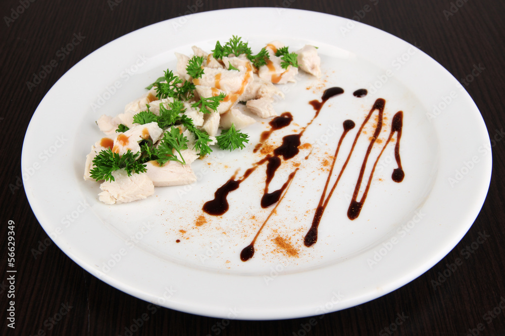 Boiled chicken meat with paprika and sauce,on white plate,