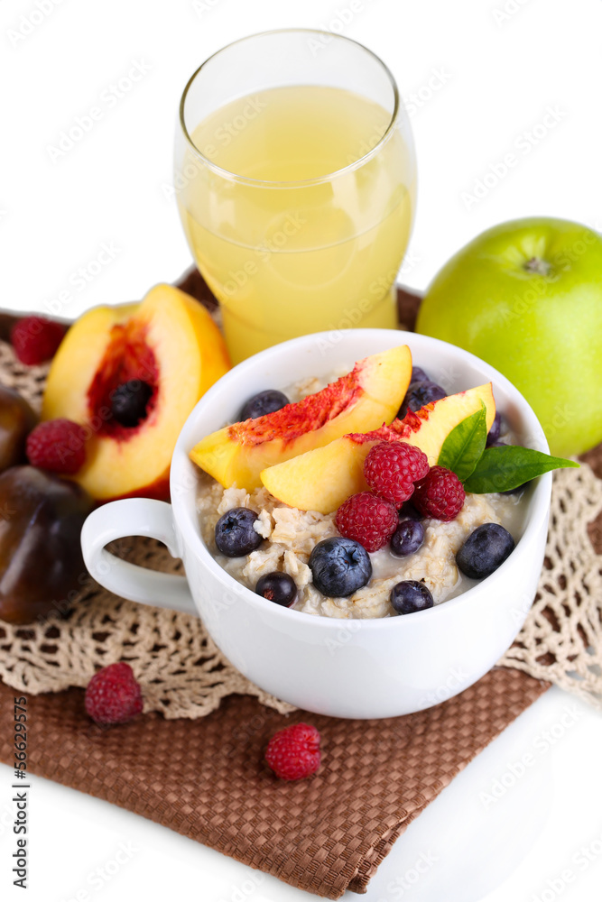 Oatmeal in cup with berries on napkins isolated on white Oatmeal in cup with berries on napkins isolated on white