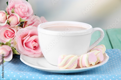 Cocoa drink on wooden table, on light background