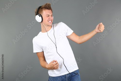 Handsome young man listenin...