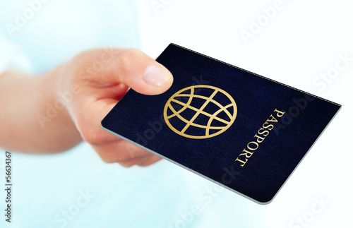 hand holding passport over white background photo