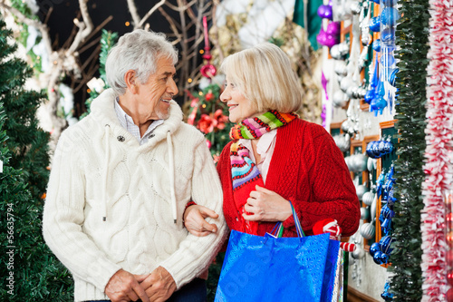 Senior Couple With Shopping Bags At Christmas Store