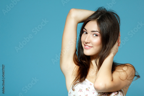 beautiful happy smiling teen girl portrait over blue © Khorzhevska
