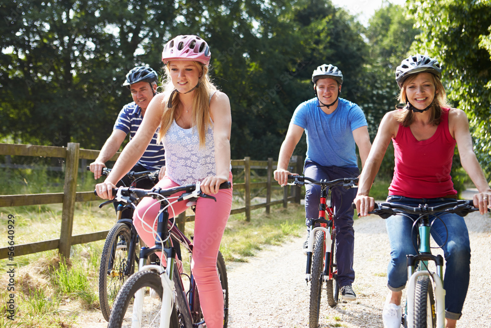 Family With Teenage Children On Cycle Ride In Countryside