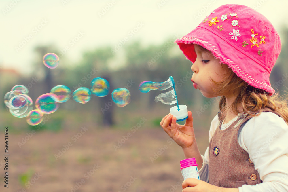 Little girl playing with soap bubbles Little girl playing with soap bubbles