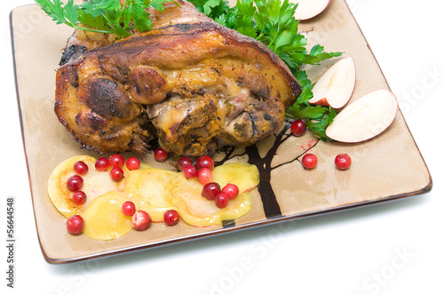 roasted pork knuckle with apples and cranberries close-up