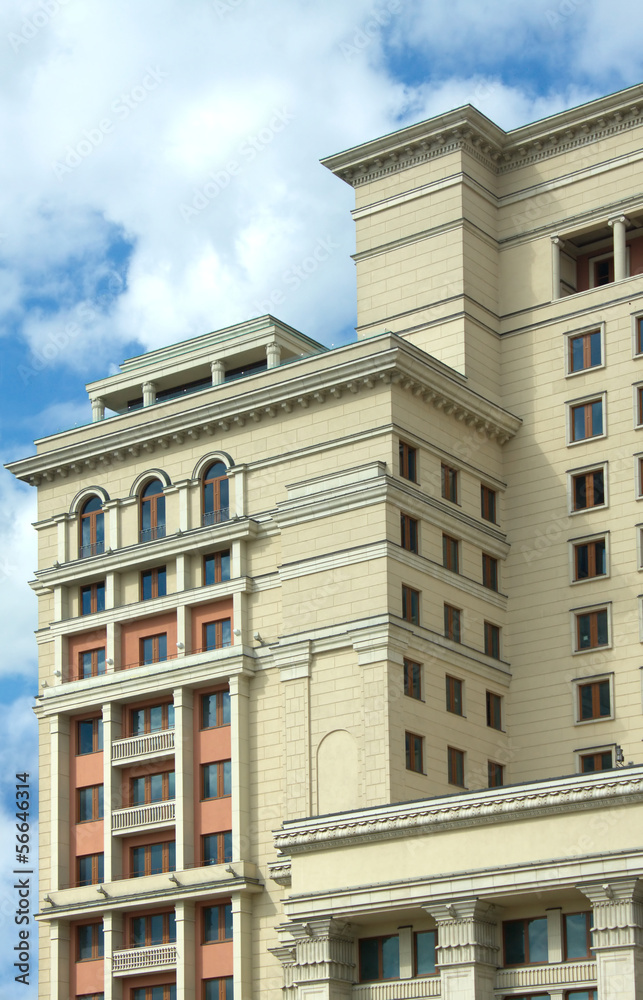 Old style soviet period brown building over sky with clouds Old style soviet period brown building over sky with clouds