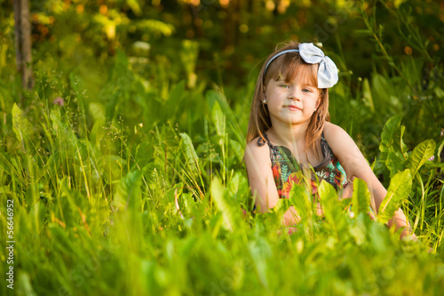 Funny lovely little girl in park