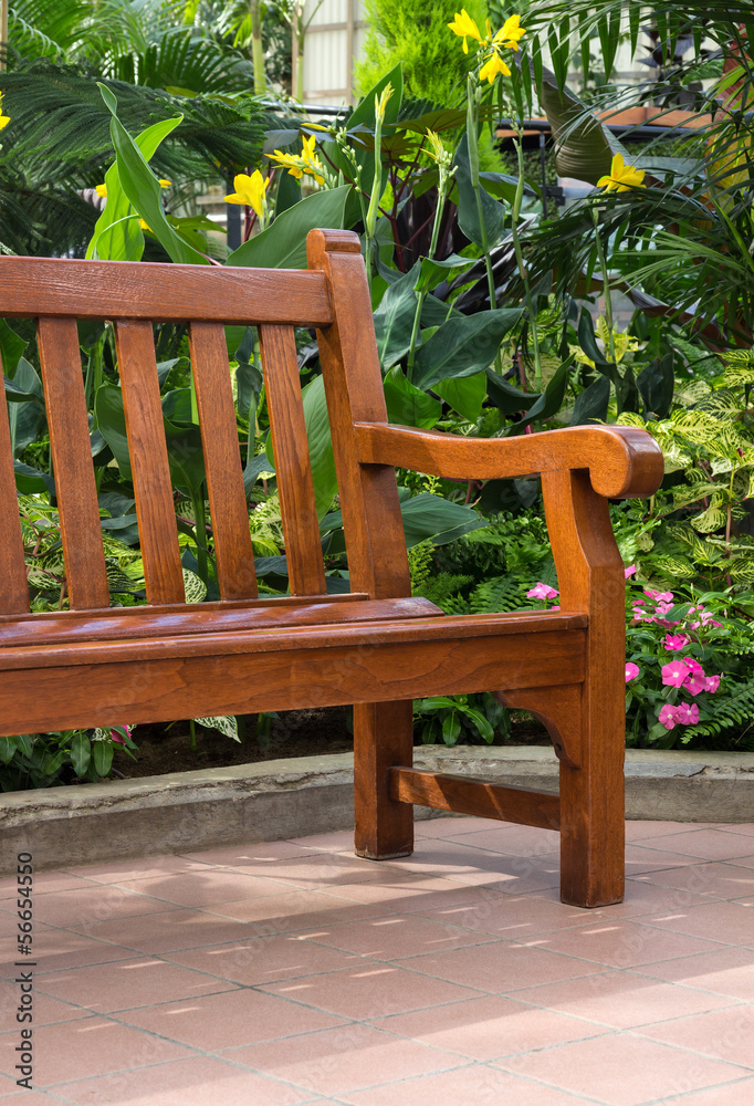 Wooden bench in the tropical garden