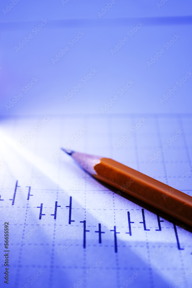 Business graph and pencil in beam of light Business graph and pencil in beam of light
