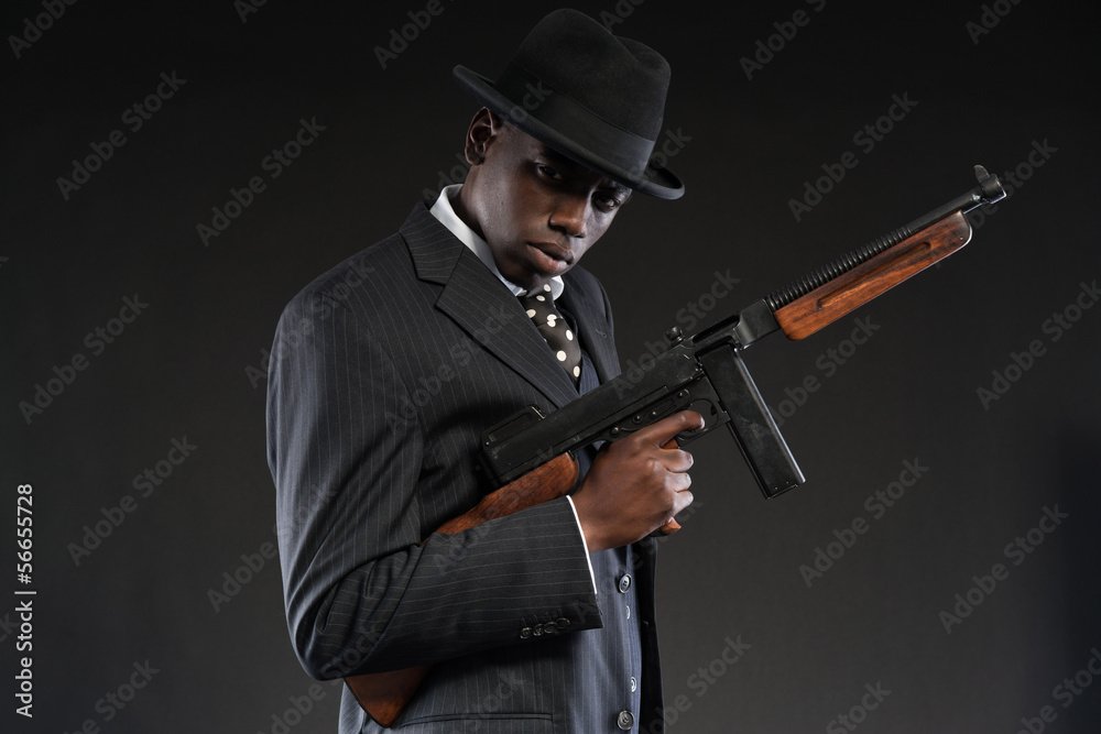 Retro african american mafia man wearing striped suit and tie an Retro african american mafia man wearing striped suit and tie an