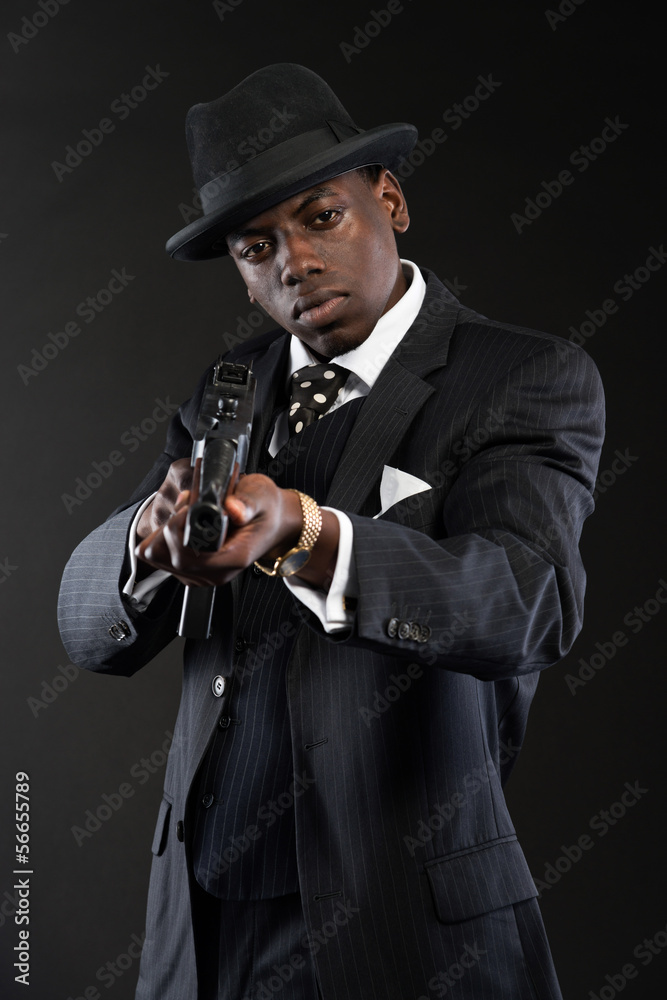 Retro african american mafia man wearing striped suit and tie an Retro african american mafia man wearing striped suit and tie an