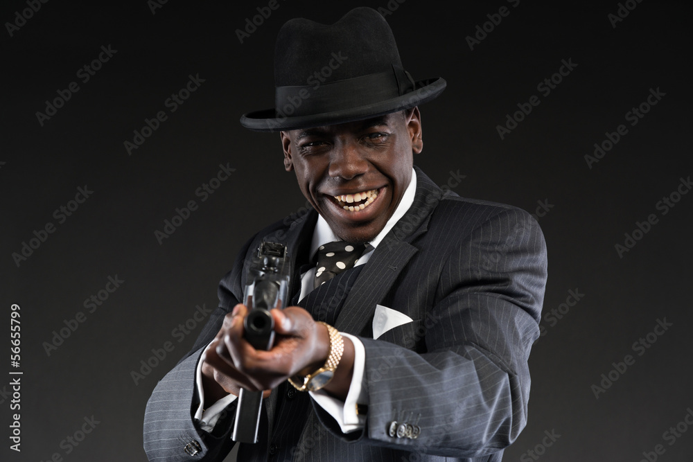 Retro african american mafia man wearing striped suit and tie an Retro african american mafia man wearing striped suit and tie an
