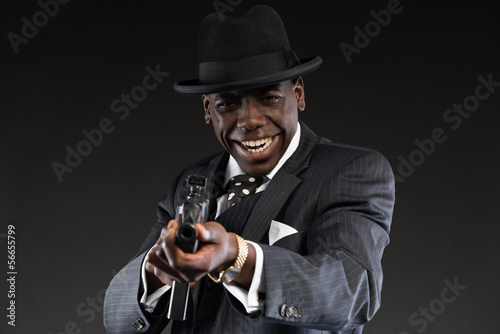 Retro african american mafia man wearing striped suit and tie an