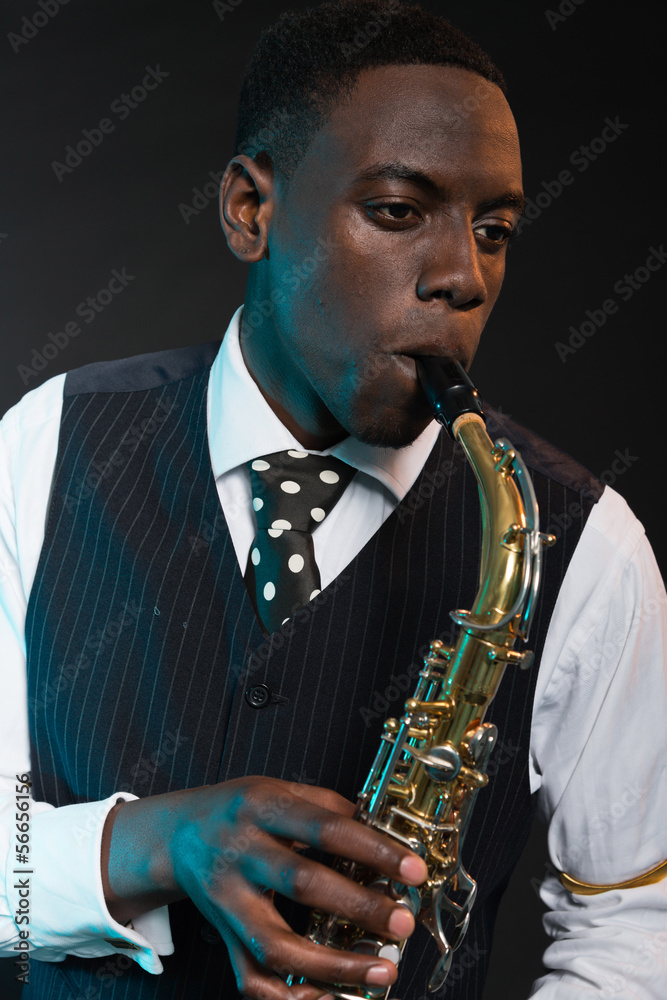 Fototapeta premium Retro african american jazz musician playing on his saxophone. W