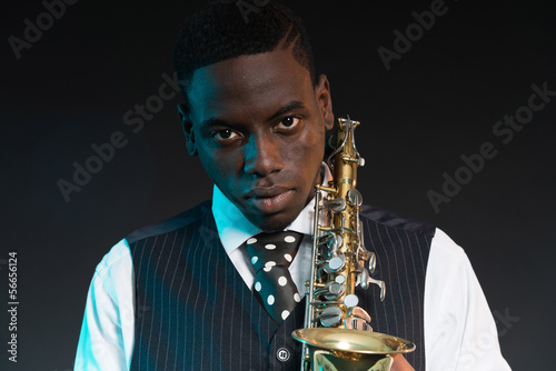 Photography Retro african american jazz musician holding his saxophone. Wear
