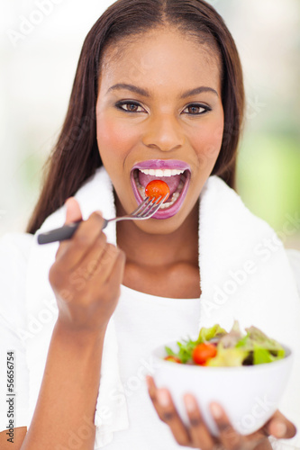african woman eating fresh salad