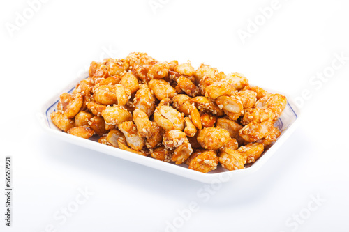 crispy peanut with sesame in plate on white background