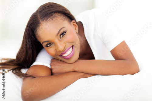 african american woman lying on bed