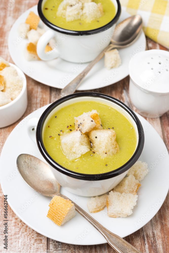 spicy zucchini soup with croutons in a cup, top view spicy zucchini soup with croutons in a cup, top view