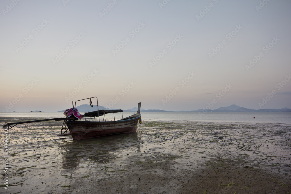 Boat on mudflats at dawn