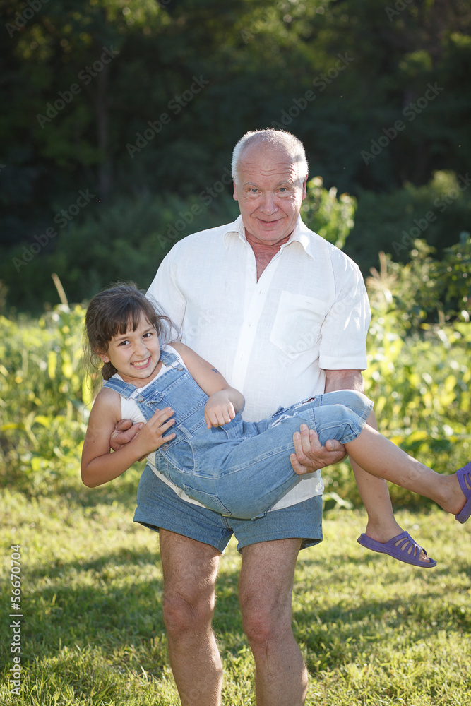 Grandfather giving granddaughter ride Grandfather giving granddaughter ride