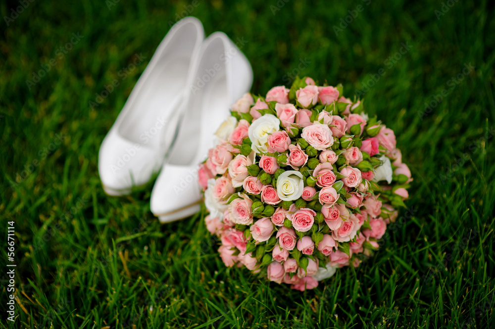 bridal bouquet and white female shoes on grass bridal bouquet and white female shoes on grass