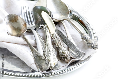 vintage cutlery with old-fashioned napkin on a silver tray