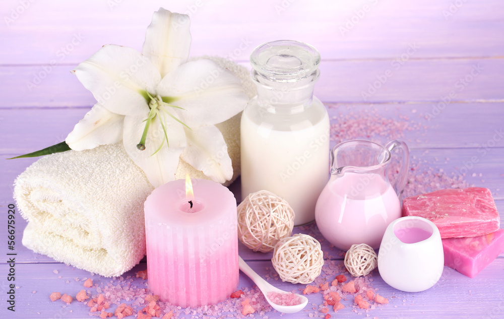 Beautiful spa setting with lily on wooden table close-up Beautiful spa setting with lily on wooden table close-up
