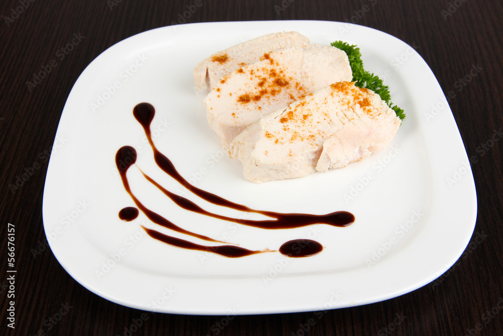 Boiled chicken meat with paprika and sauce, on wooden Boiled chicken meat with paprika and sauce, on wooden