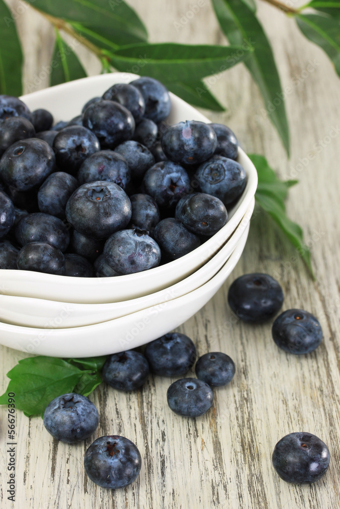 Blueberries in bowls on wooden table Blueberries in bowls on wooden table
