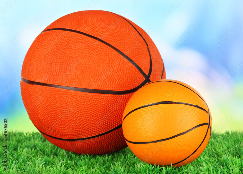 Basket balls, on green grass, on bright background Basket balls, on green grass, on bright background
