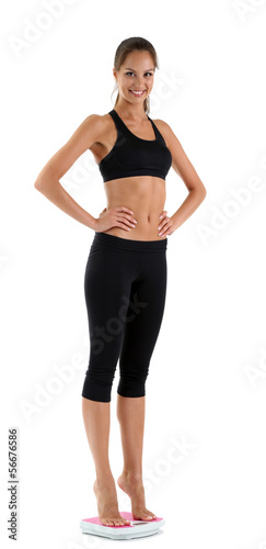 Slim young girl on scales i...