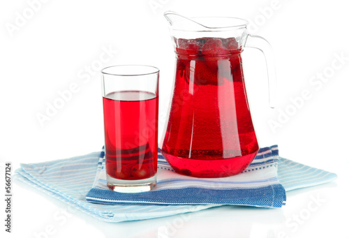 Fotografija Pitcher and glass of compote on napkins isolated on white