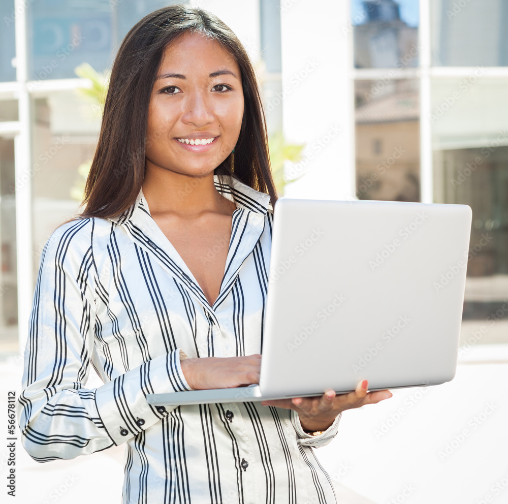 Pretty asian woman using a laptop Pretty asian woman using a laptop