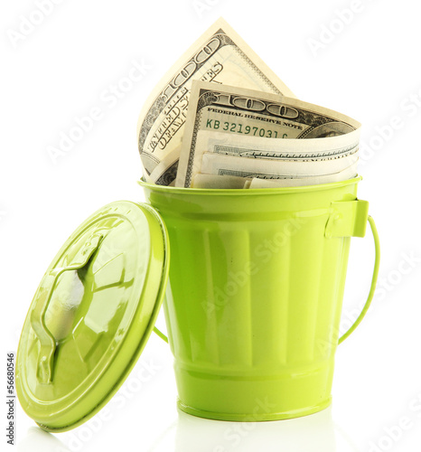 Money in trash can, isolated on white