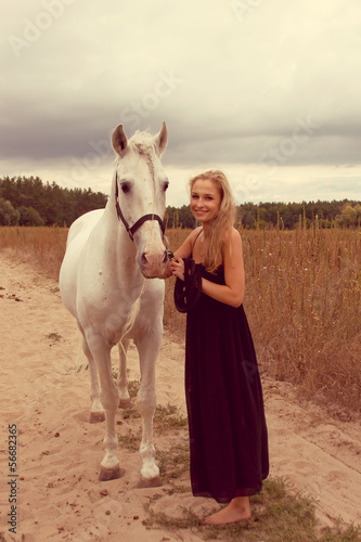 beautiful young woman with a horse