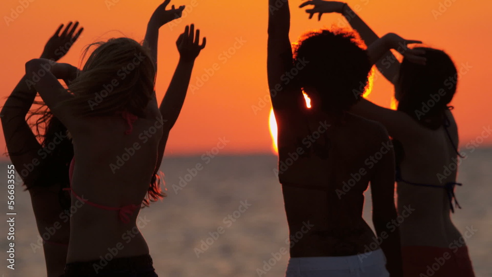 Silhouetted College Friends Laughing Dancing Beach