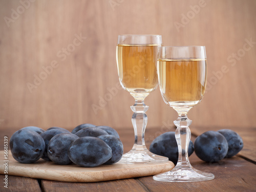 Canvas Print Plum brandy or schnapps with fresh and tasty plum