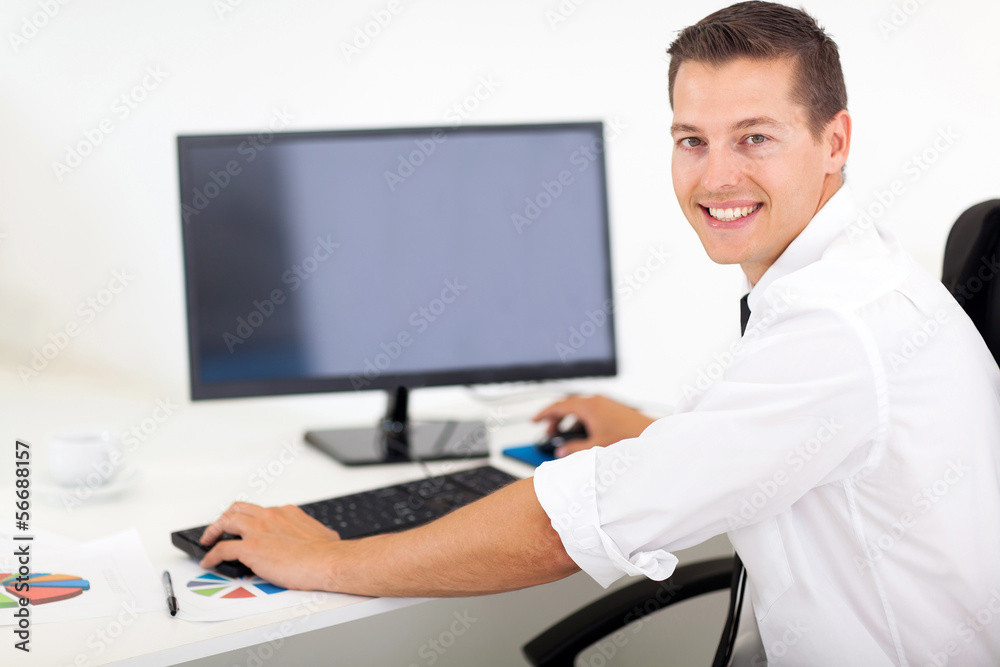 businessman working on a computer in office businessman working on a computer in office